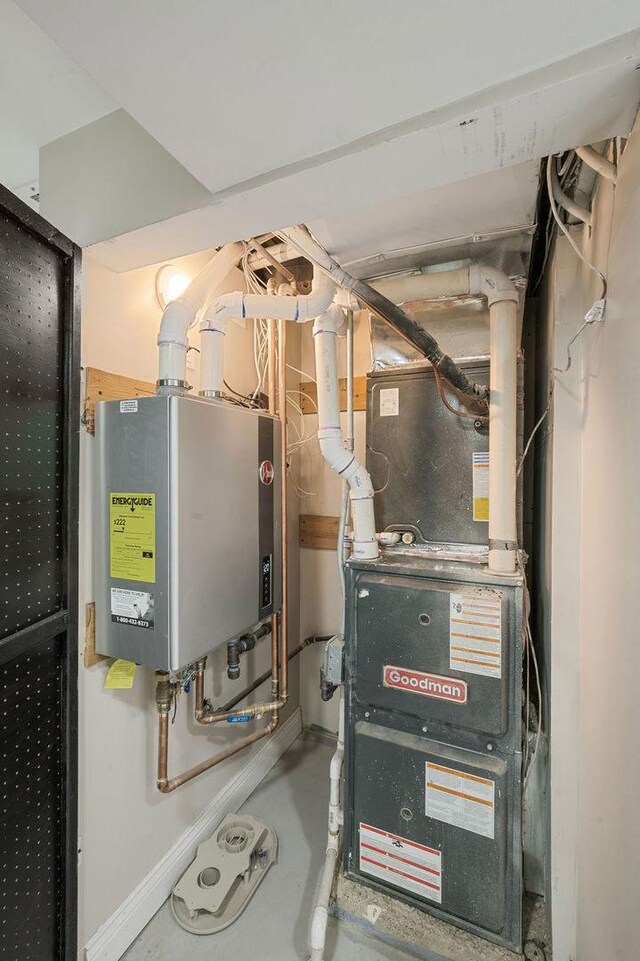 utility room featuring heating unit and water heater