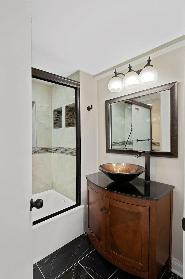 bathroom with vanity and shower / bath combination with glass door