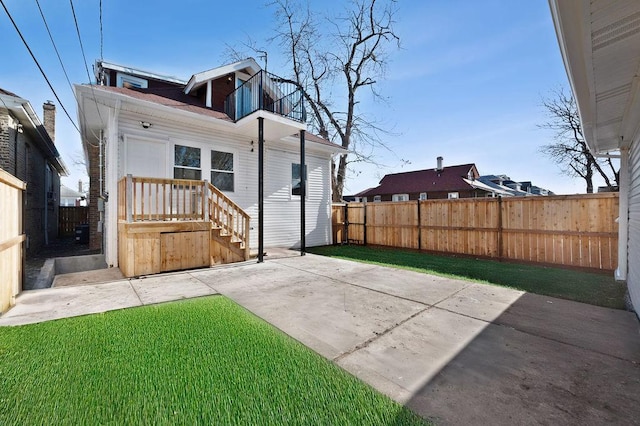 back of property featuring a patio area and a yard