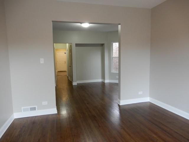 spare room featuring dark hardwood / wood-style floors