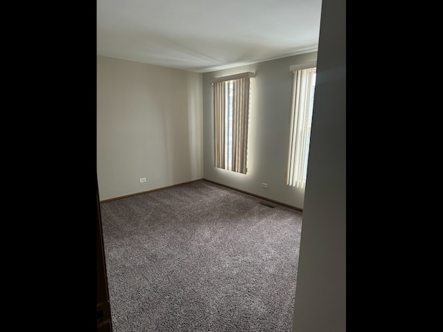 1009 Symphony Dr, Aurora, IL 60504 - carpeted empty room featuring baseboards and crown molding