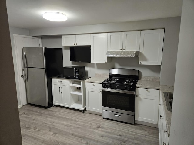 kitchen featuring white cabinetry, sink, stainless steel appliances, and light hardwood / wood-style floors