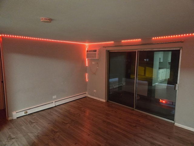 unfurnished room featuring wood-type flooring and baseboard heating