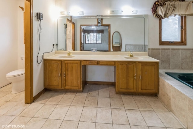 bathroom featuring a bath, toilet, tile patterned floors, and vanity