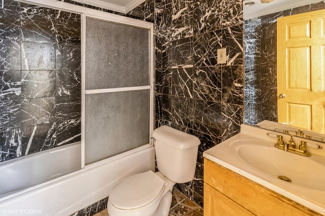 full bathroom featuring tile walls, toilet, vanity, and shower / bath combination with glass door