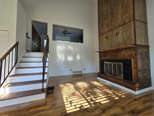 unfurnished living room featuring hardwood / wood-style flooring and ceiling fan