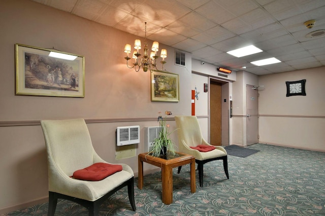 living area featuring a chandelier, a paneled ceiling, carpet floors, and elevator