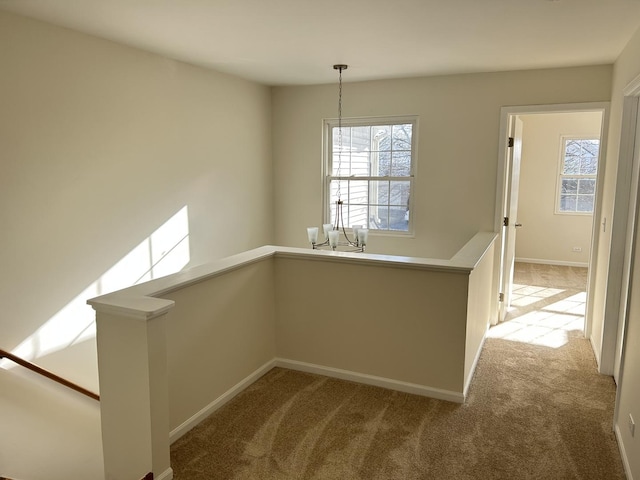 unfurnished dining area with light colored carpet