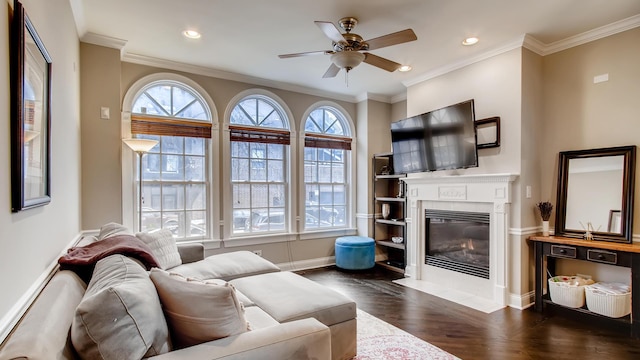 living room with dark parquet floors, ceiling fan, and ornamental molding