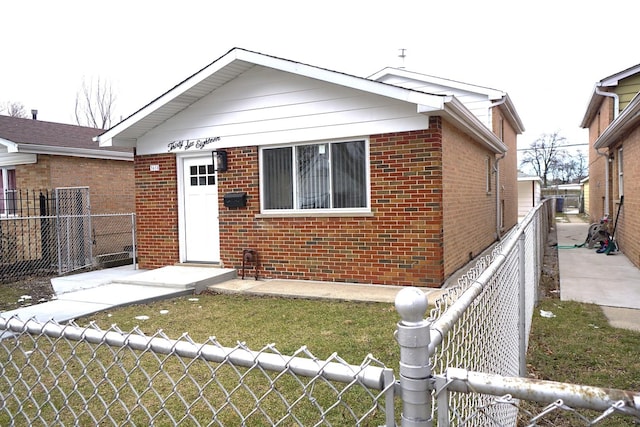 bungalow-style house with a front yard