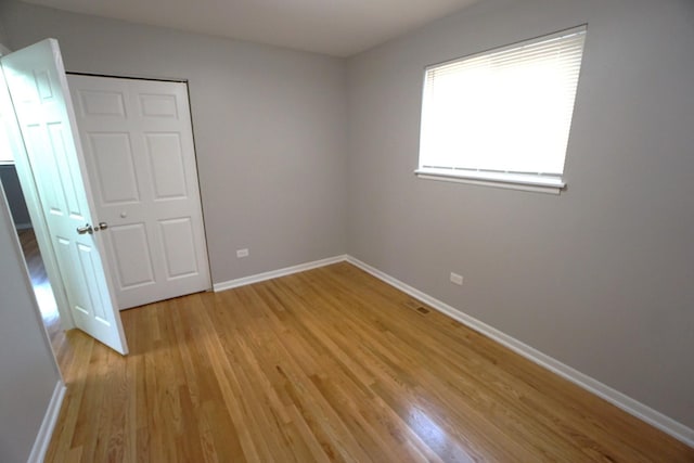 unfurnished bedroom with light wood-type flooring