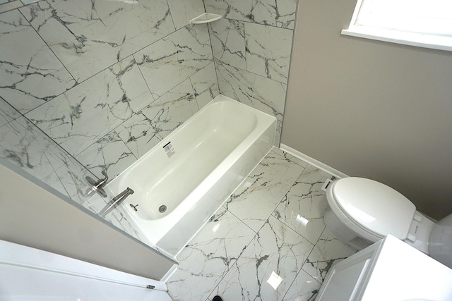 bathroom with shower / washtub combination and toilet