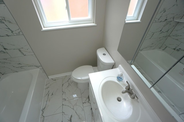 bathroom featuring toilet, a wealth of natural light, and vanity