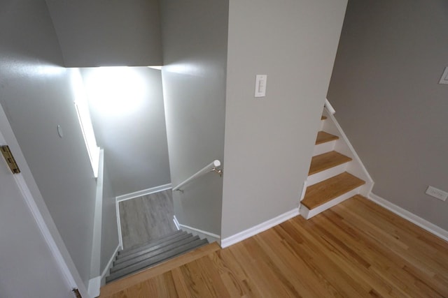 stairway with hardwood / wood-style floors