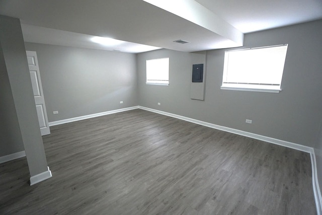 basement with dark hardwood / wood-style floors