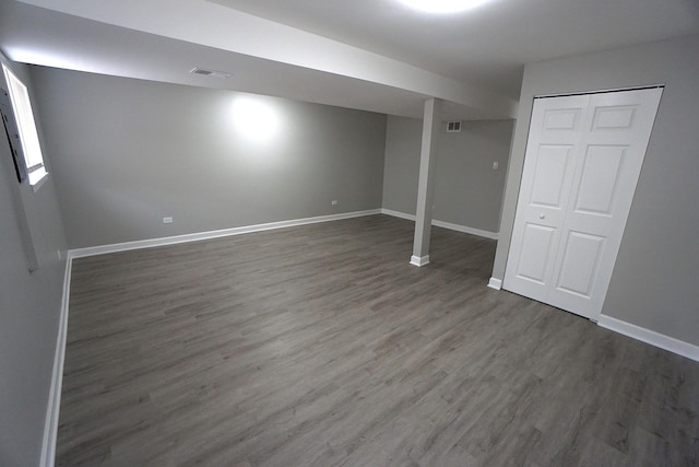 basement featuring dark hardwood / wood-style flooring