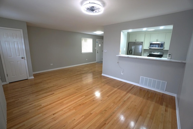 unfurnished living room with light wood-type flooring