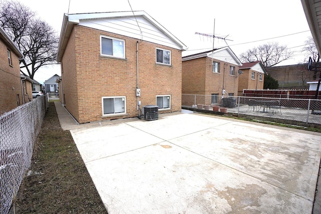 rear view of property featuring central AC