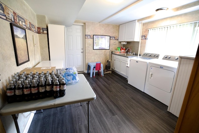 laundry area featuring cabinets, sink, dark wood-type flooring, and washer and dryer