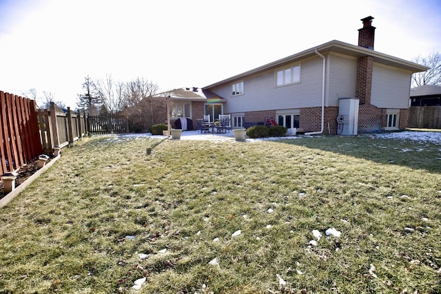 back of house with a yard and a patio area