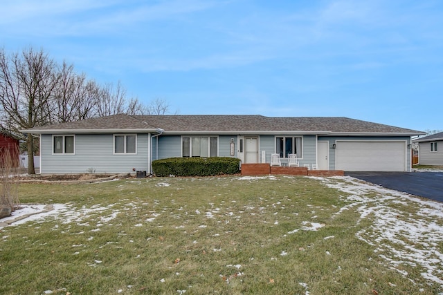 ranch-style home with a garage and a front yard