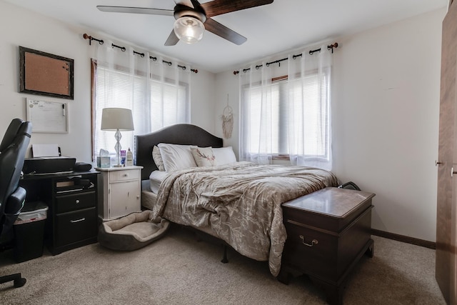 carpeted bedroom featuring ceiling fan and multiple windows