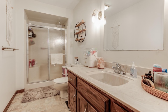 bathroom featuring vanity, toilet, and a shower with door