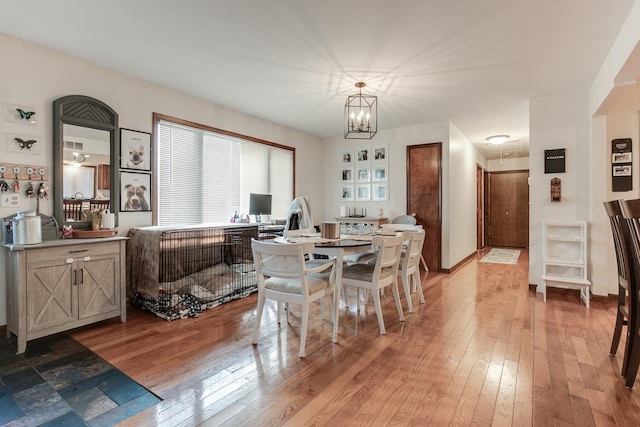 dining room featuring a chandelier and light hardwood / wood-style flooring