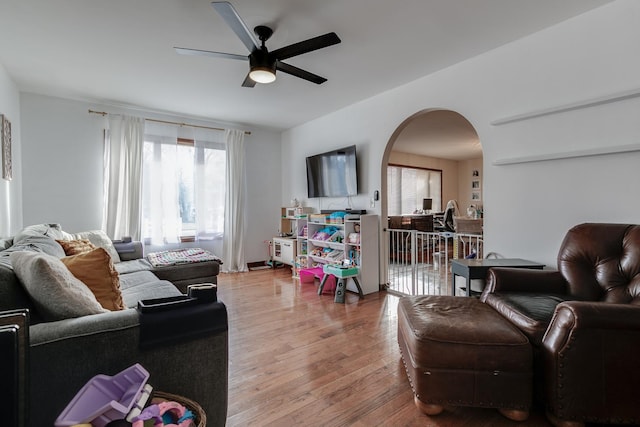 living room featuring hardwood / wood-style floors and ceiling fan