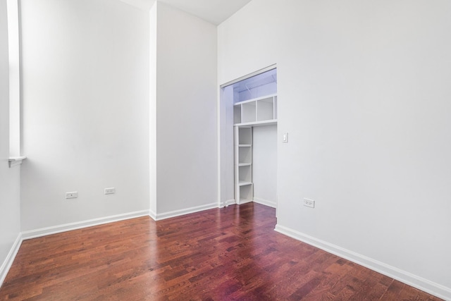 empty room featuring dark wood-type flooring