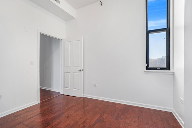 empty room featuring dark wood-type flooring