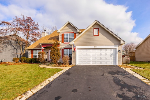 view of property featuring a garage and a front lawn