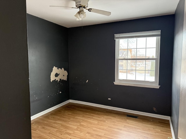 spare room featuring ceiling fan and light wood-type flooring