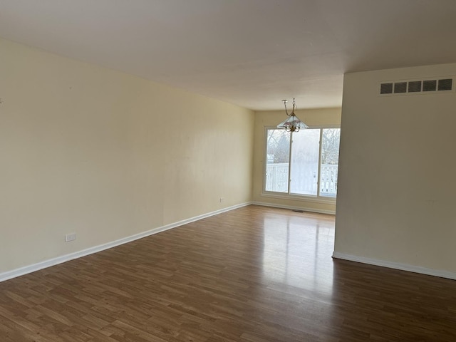 unfurnished room with dark wood-type flooring