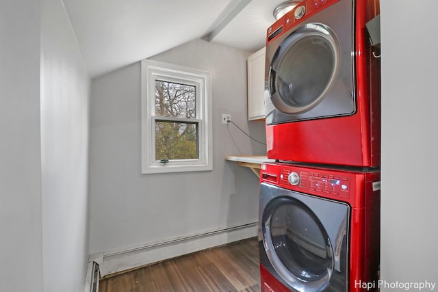 clothes washing area with cabinets, baseboard heating, dark hardwood / wood-style flooring, and stacked washing maching and dryer