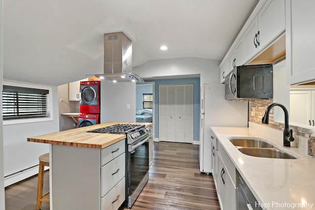 kitchen featuring gas range, white cabinets, butcher block countertops, stacked washer / drying machine, and island range hood