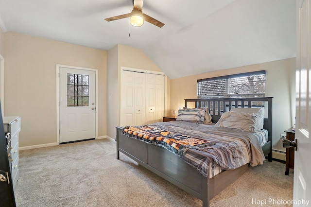 carpeted bedroom featuring lofted ceiling, multiple windows, a closet, and ceiling fan