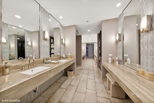 bathroom featuring double vanity, a sink, and recessed lighting