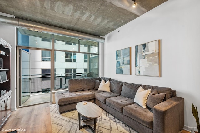 living area featuring light wood-type flooring and expansive windows