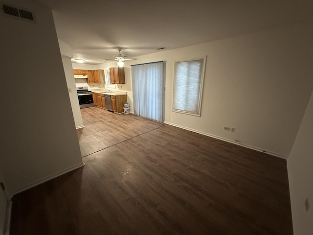 unfurnished living room featuring ceiling fan and hardwood / wood-style floors