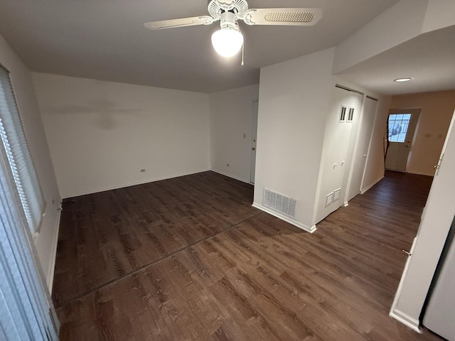 spare room with dark hardwood / wood-style floors and ceiling fan