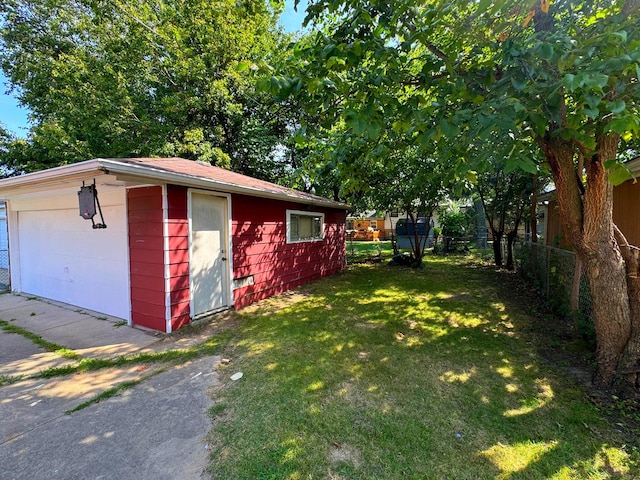 view of outbuilding with a garage and a lawn