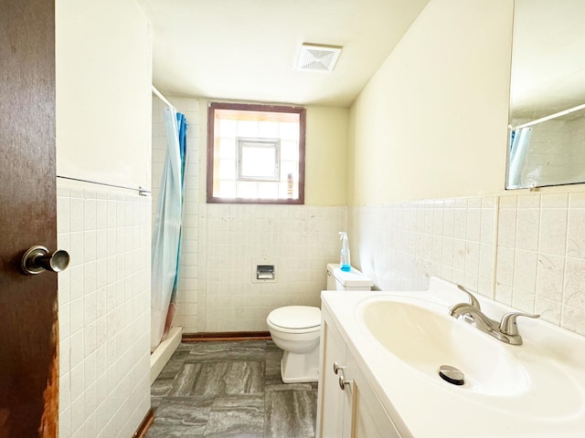 bathroom featuring vanity, toilet, tile walls, and a shower with shower curtain