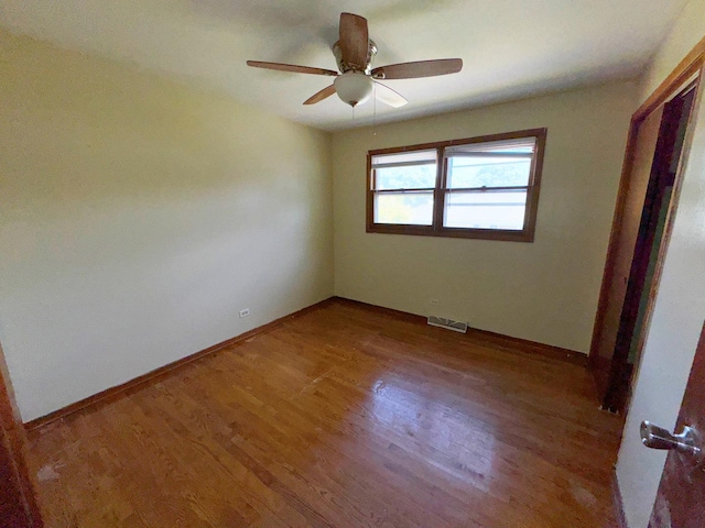 unfurnished room with ceiling fan and wood-type flooring