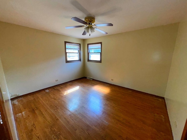 unfurnished room featuring hardwood / wood-style flooring and ceiling fan