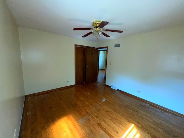 spare room featuring wood-type flooring and ceiling fan