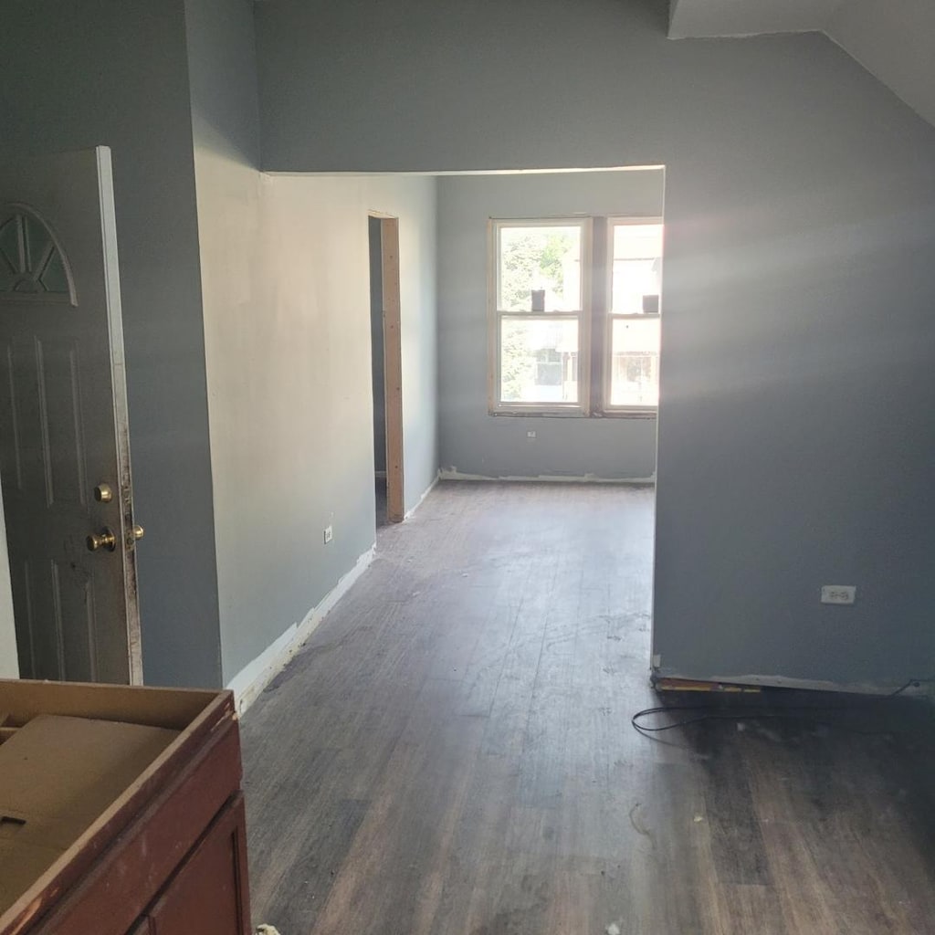 interior space with hardwood / wood-style floors and lofted ceiling