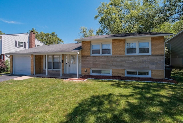 tri-level home with a front yard, a porch, and a garage