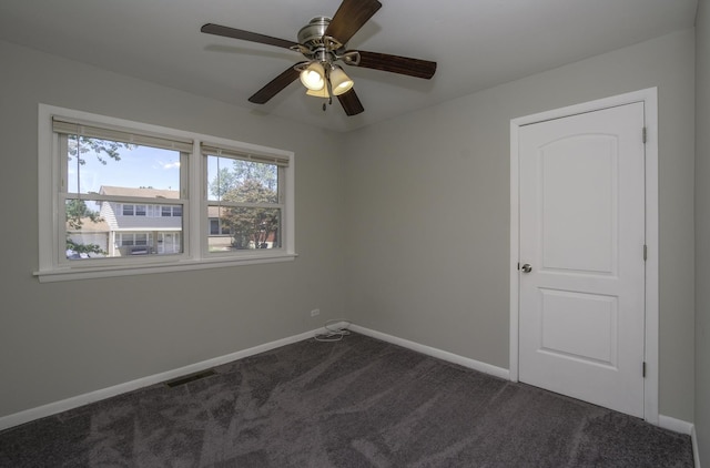 carpeted empty room with ceiling fan