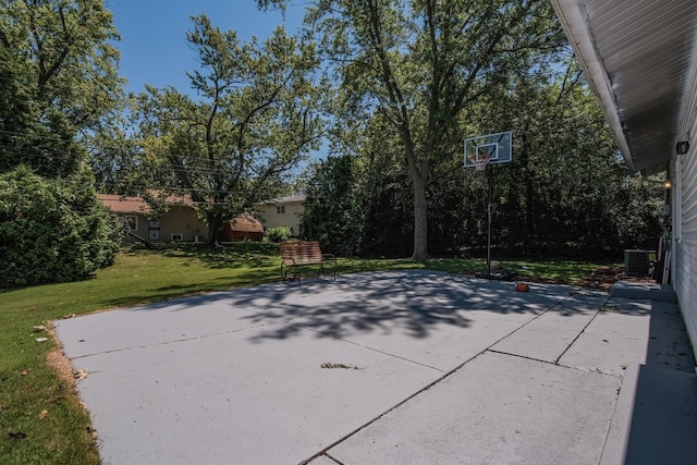 view of basketball court with a yard